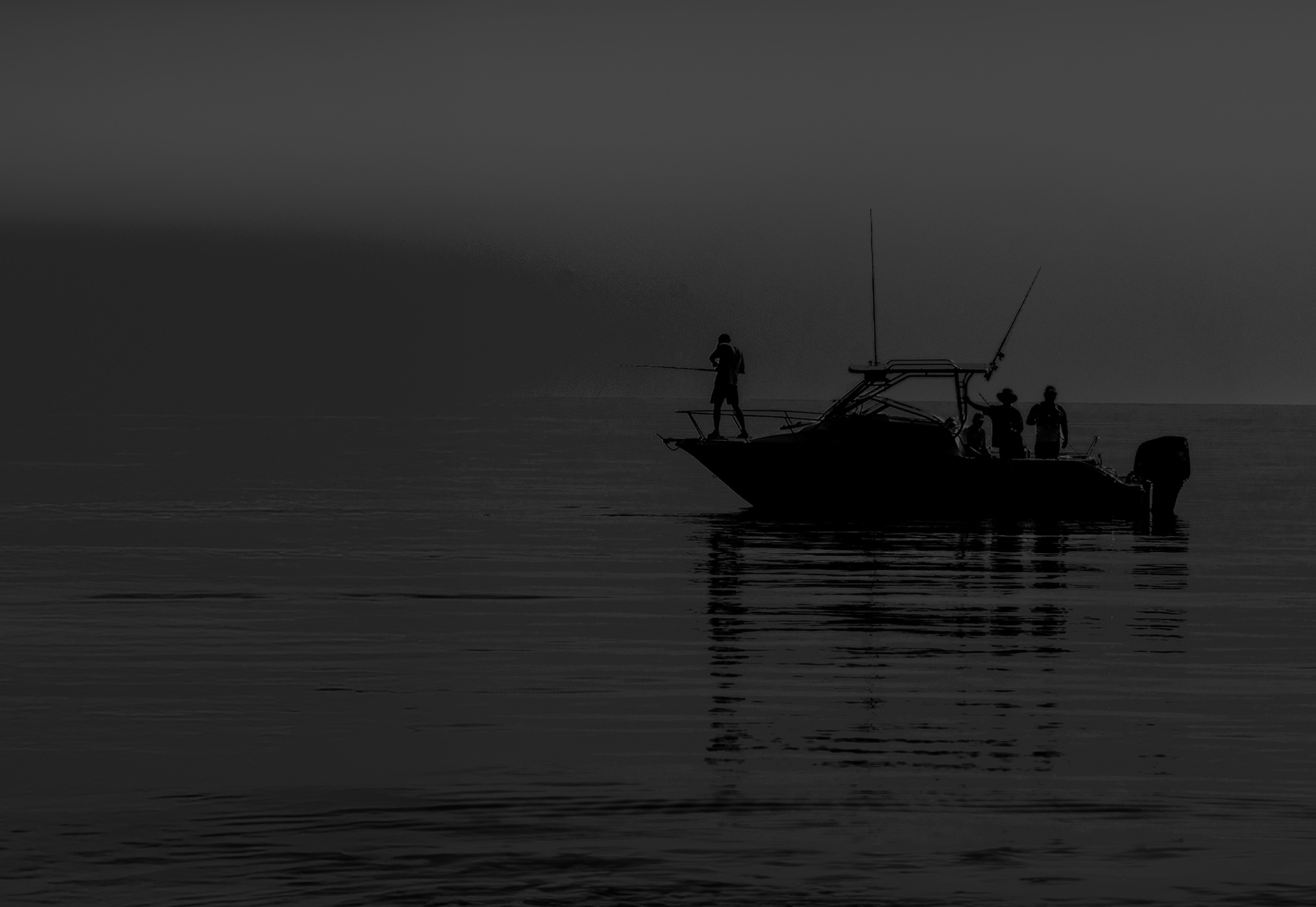 Lone fishing boat on a still sea at dusk